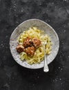 Fettuccine pasta with chicken teriyaki meatballs on a dark background, top view Royalty Free Stock Photo