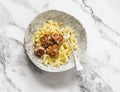 Fettuccine pasta with chicken teriyaki meatballs on a light background, top view Royalty Free Stock Photo