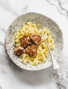 Fettuccine pasta with chicken teriyaki meatballs on a light background, top view Royalty Free Stock Photo