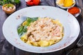 Fettuccine pasta with seafood, squid rings, shrimp, mussels, oysters, tomato, parmesan cheese, basil and cream sauce