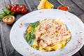 Fettuccine pasta with seafood, squid rings, shrimp, mussels, oysters, tomato, parmesan cheese, basil Royalty Free Stock Photo
