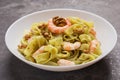 Fettuccine pasta with shrimp, pesto sauce, walnut on white dish. Pasta seafood. Mediterranean cuisine Royalty Free Stock Photo