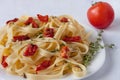 Fettuccine pasta with sun-dried tomatoes and rosemary. Close up Royalty Free Stock Photo