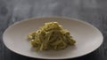 fettuccine pesto on white plate closeup