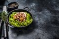 Fettuccine spinach pasta with seafood in cream sauce. Black background. Top view. Copy space