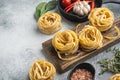 Fettuccine Tagliatelle pasta Italian food ingredients, on gray stone background, with copy space for text Royalty Free Stock Photo