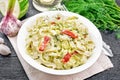 Fettuccine with zucchini and hot peppers in plate on napkin