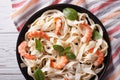 Fettuccini pasta in cream sauce with shrimp close-up. horizontal