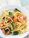 Fettuccini with shrimps and basil leaves