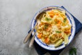 Fettucine pasta with salmon and parmesan cheese in creamy sauce in ceramic plate on old gray concrete background. Royalty Free Stock Photo