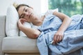 Feverish woman lying under blanket