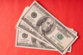 A few American dollars on a paper red background Royalty Free Stock Photo