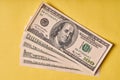 A few American dollars on a paper yellow background Royalty Free Stock Photo