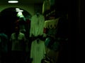 A few bags in a tourist shop in Rovinj, croatia during the night, with people in the background