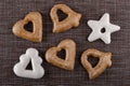 Brown and white gingerbreads different shape on mat. Top view