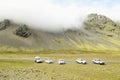 Cars parked near mountains in south Iceland