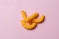 A few cheese doodles on pink background.. Royalty Free Stock Photo