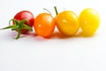 Few cherry tomatoes in a row for color nuance on white background