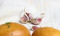 A few cloves of garlic with blurred buns in the foreground Royalty Free Stock Photo