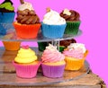 Few colourful cupcakes on street market. Royalty Free Stock Photo