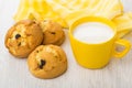 Few curd biscuits with raisin, milk, striped yellow napkin