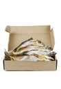 Few cured white-eye bream Ballerus sapa fishes in cardboard box isolated on a white
