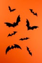 Black paper bats on vertical orange background Royalty Free Stock Photo