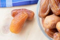 A few of dried sweet deglet nour date fruites on wooden table.Organic vegetarian food.