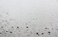 A few drops of rain on the window pane outside the window gray sky Royalty Free Stock Photo