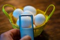 A few eggs in a breakfast basket which are viewed with a magnifying glass