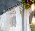 Few elegant wedding, bridesmaid ,evening, ball gown or prom dresses on a hanger in a bridal shop Royalty Free Stock Photo