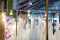 Few elegant wedding, bridesmaid ,evening, ball gown or prom dresses on a hanger in a bridal shop Royalty Free Stock Photo