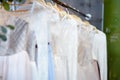 Few elegant wedding, bridesmaid ,evening, ball gown or prom dresses on a hanger in a bridal shop Royalty Free Stock Photo