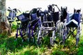 Few empty wheelchairs old wheelchairs are left behind after being used by deceased elderly people