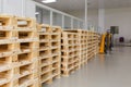 Few empty wooden pallets for storage in an empty warehouse. Royalty Free Stock Photo