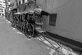 Few famous hand pulled rickshaw parked road side on streets of Kolkata in black and white Royalty Free Stock Photo