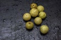 Few fresh organic gooseberries on a black background with selective focus Royalty Free Stock Photo