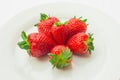 Few fresh strawberries on a white plate. Royalty Free Stock Photo