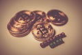 A few gold coins with the sign of bitcoin and the inscription `accepted here`. Gold toned image