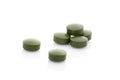 Few green pills isolaed on white background. Royalty Free Stock Photo