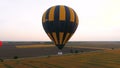 Few hot air balloons flying over fields, road running amidst, industrialization