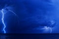 A few lightning bolts over the sea at night Royalty Free Stock Photo