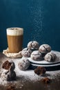 A few marble brown cookies with glass of coffee latte, star anise and powdered sugar