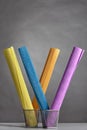 Colorful rolls of wrinkled corrugated paper stand vertical in ba Royalty Free Stock Photo