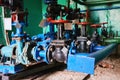 A few old black valves with red handles on a cold blue water pipe. Royalty Free Stock Photo