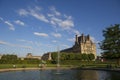 A few people gather around a water-fountain located near the Ecole du Louvre Royalty Free Stock Photo