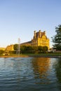 A few people gather around a water-fountain located near the Ecole du Louvre Royalty Free Stock Photo