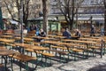 Few People in a german Biergarten Outdoor Beer Pub at the Viktualienmarkt Victuals Market in Munich in the spring Coronawave