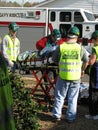 Few people helping transport injured person