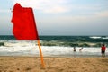 A few people refuse the head the red flag warning of dangerous and rough surf at the beach